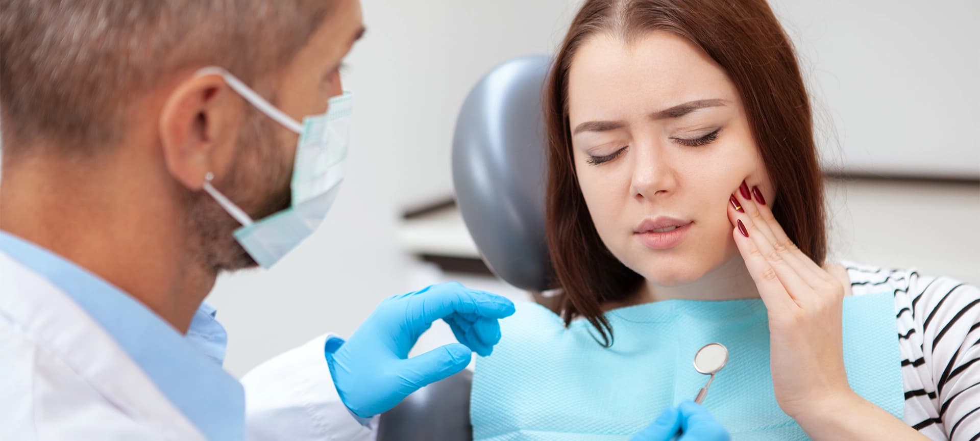 Brisbane dentist reviewing file in clinic.