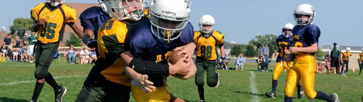 Young athlete smiling confidently on a sports field.